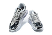 Pair of silver and black Nike Air Max 90 sneakers viewed from above.