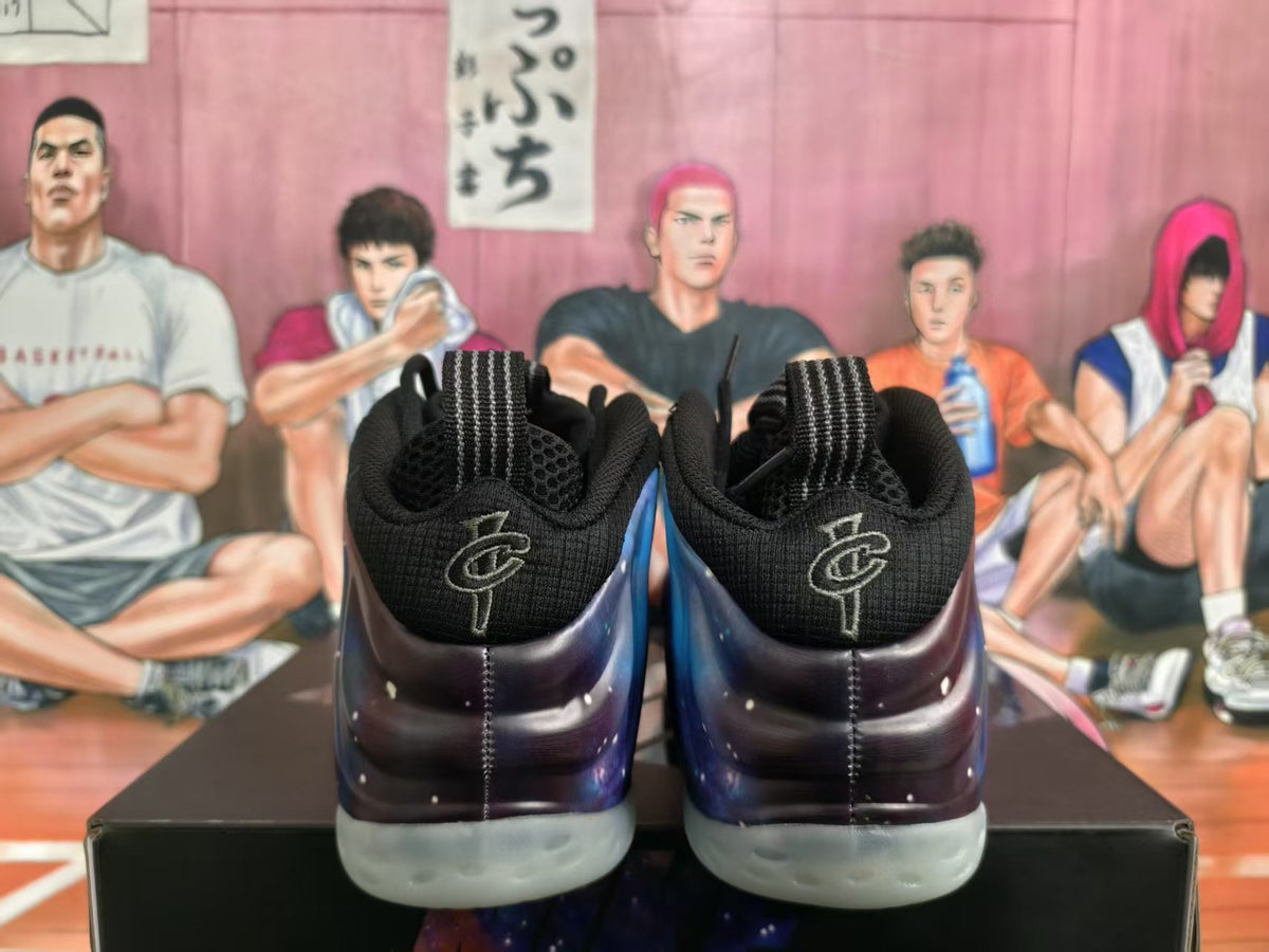 Rear view of black Nike sneakers with galaxy-patterned side panels and translucent outsoles.