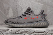 Profile view highlighting the dark grey upper, black patterning, red side lettering and translucent outsole.