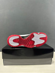 Bottom view showing the red outsole and white herringbone traction sections.