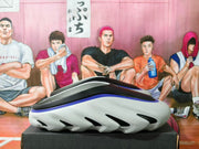Side view of a gray slip-on shoe with black and blue accents and a sculpted sole.