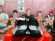 Front view showing the patterned toes, black laces, and red accents