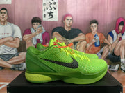 Side view of a green Nike Kobe basketball shoe showing the black side logo and Nike Zoom midsole branding