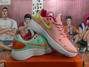 Angled view of pink and mint Nike sneakers showing the contrasting panels, swooshes, laces, and outsoles.