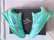 Pair of turquoise basketball shoes with blue accents and colorful patterned panels.