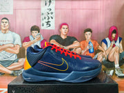 Side view of navy Nike Kobe basketball shoes with orange-red laces and yellow-orange accents
