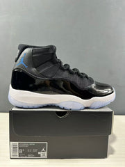 Side view of a black and blue Jordan Air Jordan 11 high-top sneaker displayed on its shoebox; the box label shows size 8.5, EU 42, and style code CT8012 900.