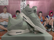 Angled view of gray high-top sneakers showing mesh-style side panels, lace hardware, and visible side air windows.