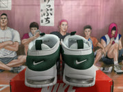 Rear view of the sneakers showing dark green heel panels, white Nike logos, pull tabs, and sole windows.