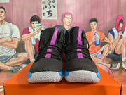 Front view of black high-top basketball shoes with purple lace details and blue toe-side accents.