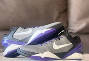 Pair of gray and purple basketball shoes shown in a side-by-side arrangement.