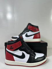 Close three-quarter view highlighting the red collar and heel, black overlays, white side panel, and black Swoosh.