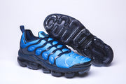 Blue and black Nike Air VaporMax Plus sneaker beside an outsole view.