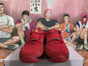 Front view of red Nike basketball sneakers with red laces, textured uppers, and metallic-tone lace details.