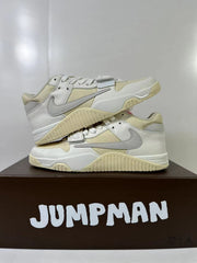 Stacked side view highlighting the textured cream outsole, layered upper, and forefoot strap.