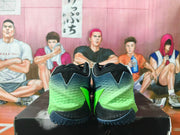 Rear view of navy and bright green Nike basketball shoes showing the heel panels and outsole.