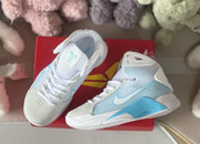 Top view of a Nike HD2008 kids sneaker showing its mesh tongue, white laces, and pale blue detailing.