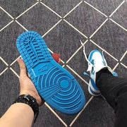 Underside view showing the blue rubber outsole and circular traction pattern.