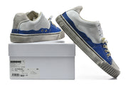 Sneakers displayed on a box with a visible Maison Margiela label.