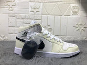 Side profile of a cream and white mid-top sneaker with black detailing and a clear bag containing an extra black lace accessory.