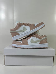 Pair of Jordan Air Jordan 1 Low sneakers stacked on a white shoebox, showing the side panels and outsole edges.