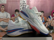 Angled view of the pair of white and blue Nike sneakers highlighting the side panels, heel structure and multicolor outsole.