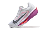 Angled side view of a white Nike Zoom Fly 6 shoe with pink and purple accents.