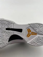 Close-up of the white outsole with black traction sections and a gold-toned Kobe logo