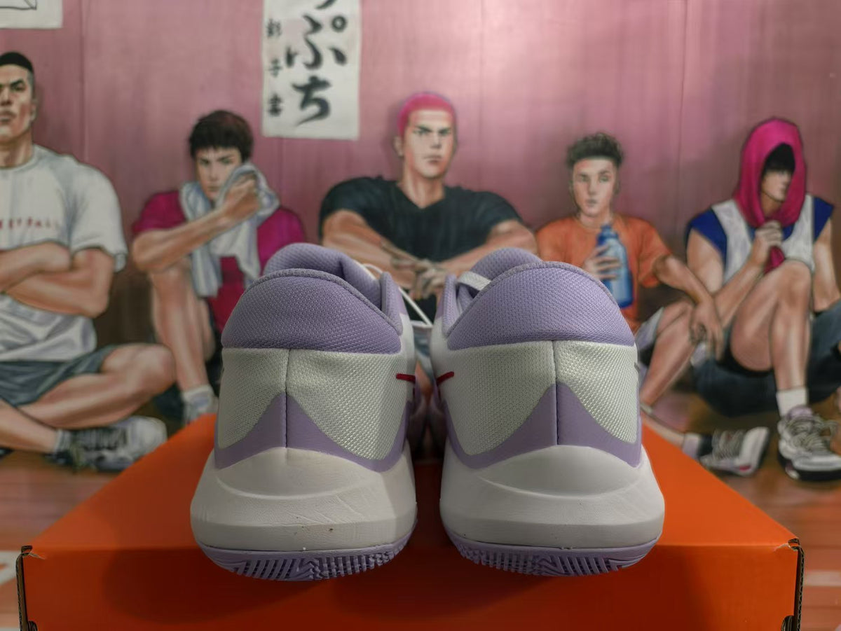 Rear view of white and light purple Nike basketball sneakers resting on an orange box.