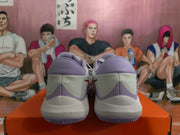 Rear view of white and light purple Nike basketball sneakers resting on an orange box.