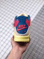 Rear view showing the blue heel panel, pink Nike branding, and yellow midsole.