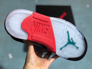 Outsole view showing translucent rubber sections, a red central panel, and turquoise Jordan detailing.