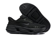 Black Nike Comfort Ride EasyOn sneakers shown from the side and underside.