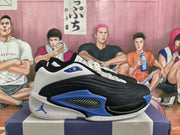 Side view showing the black upper, white panels, blue accents, and checkerboard detail