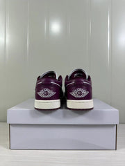 Rear view of the sneakers showing Jordan winged branding on the burgundy heel panels.