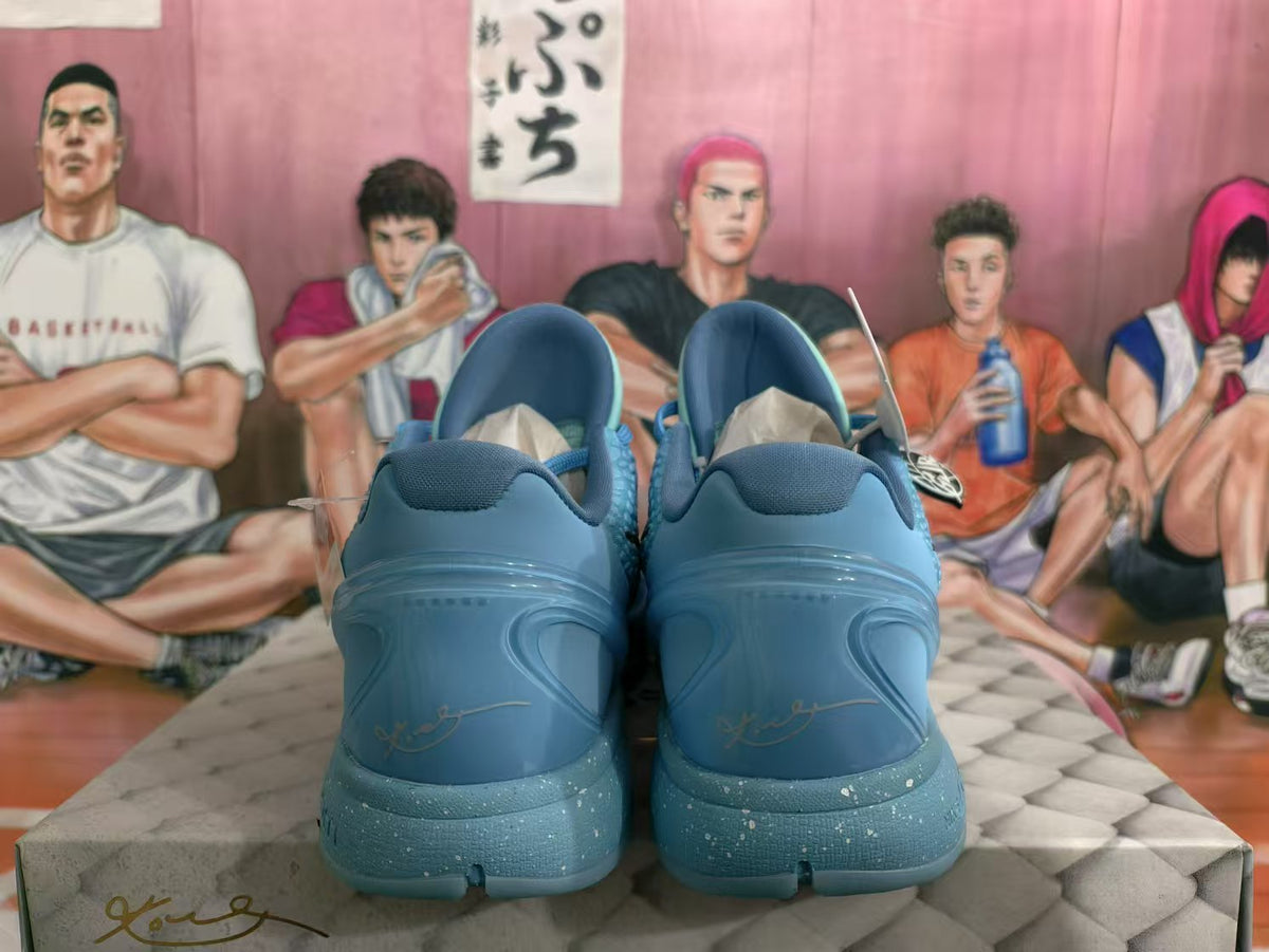 Rear view of blue Nike basketball sneakers showing the padded collars, heel panels, and textured blue soles.