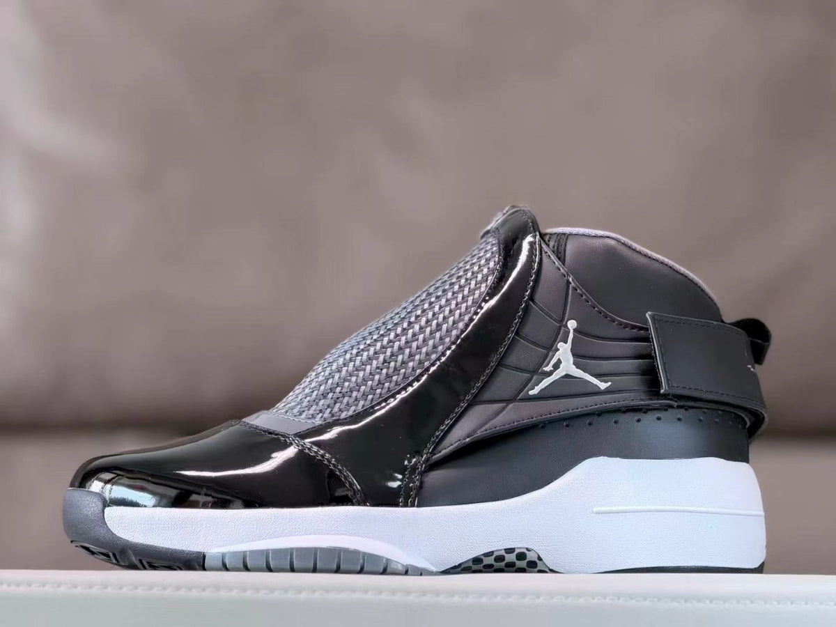 Side view of black and gray Jordan 19 high-top sneakers with a white midsole