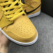 Close-up of the yellow perforated toe box, laces, stitching, and white midsole.
