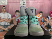 Front view showing turquoise laces, gray textile-style uppers, purple collar details, and light-colored soles.