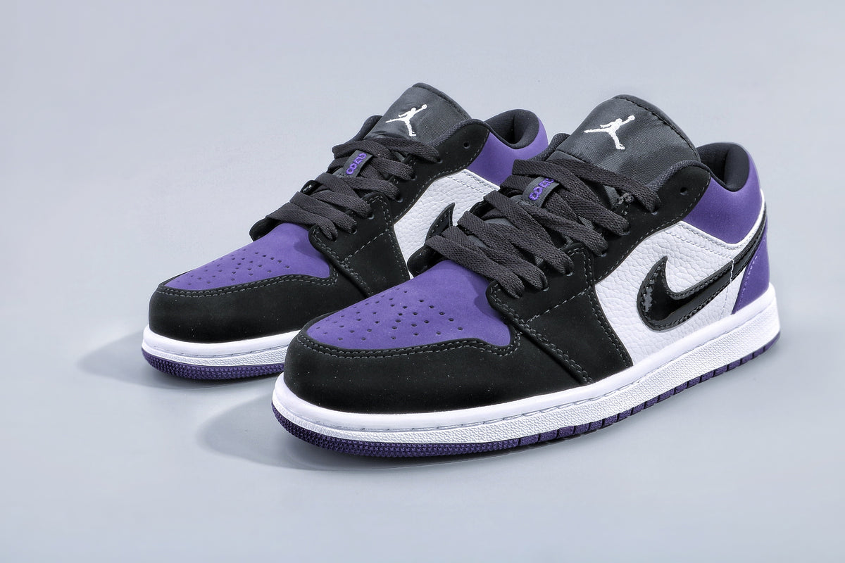 Pair of low-top Jordan sneakers in purple, black, and white, shown from a three-quarter angle.
