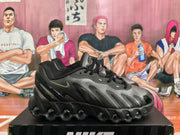 Side view of a black and silver Nike sneaker with layered panels, swoosh branding, and a sculpted circular-cushion outsole.