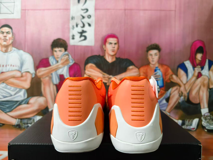 Rear view of orange and white Nike Kobe basketball shoes