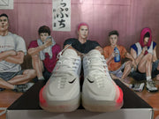 Front view of the pair showing white laces, black toe Swooshes and peach-pink accents.