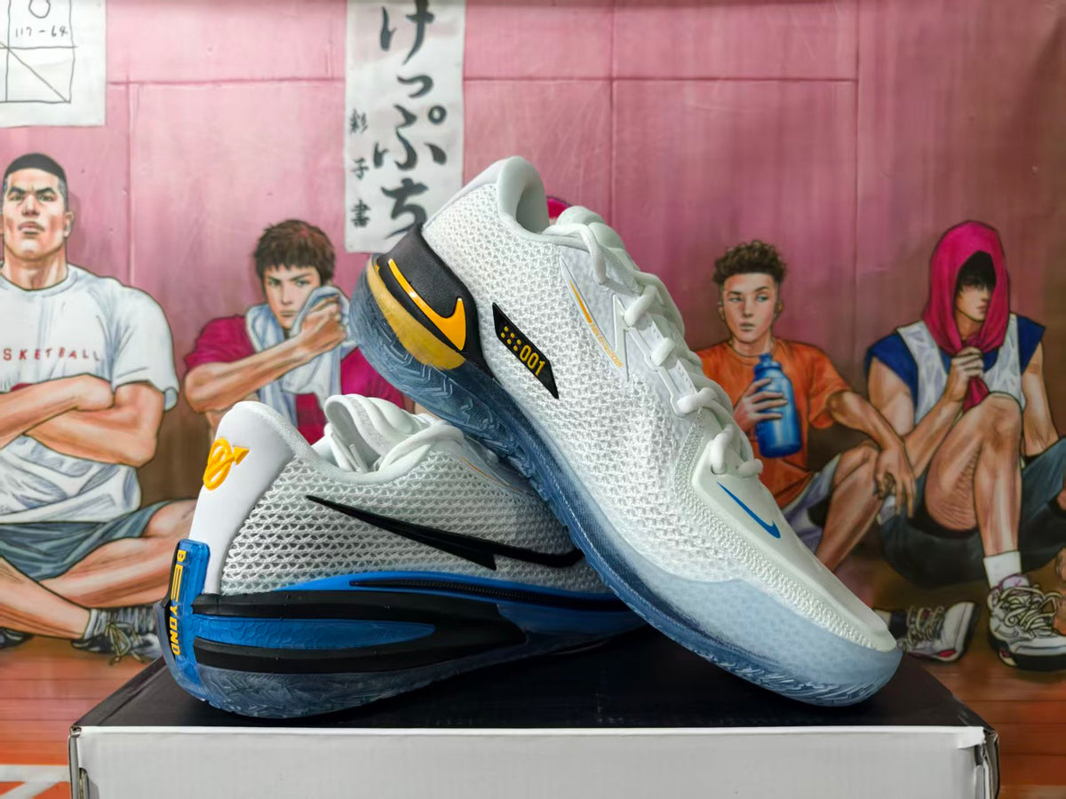 Nike GT basketball shoes in white with blue, black, and yellow details, shown in a crossed side view.
