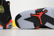 Close-up of the black sneaker outsole with translucent sections and a bright infrared Jordan emblem.