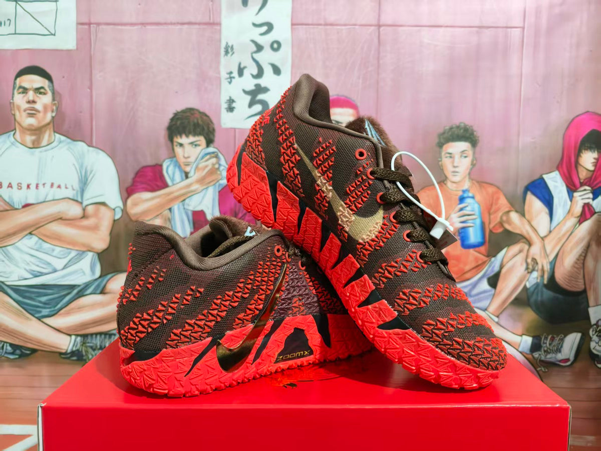 Red and black Nike basketball sneakers arranged on a red shoebox, showing the side panels, Swoosh logos, and patterned red outsoles.