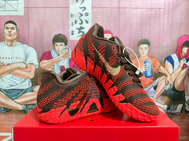 Red and black Nike basketball sneakers arranged on a red shoebox, showing the side panels, Swoosh logos, and patterned red outsoles.
