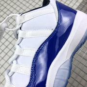 Close-up of white laces, white upper panels, and glossy blue overlay stitching.
