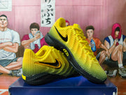 Pair of yellow and black Nike basketball shoes shown from the side