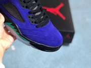 Close-up of the purple toe box, black laces, and turquoise midsole detail.